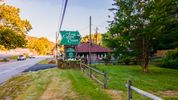 The front sign of the Log Cabin Motor Court in Asheville NC, offering historic cozy cabins to rent in the blue ridge mountains.